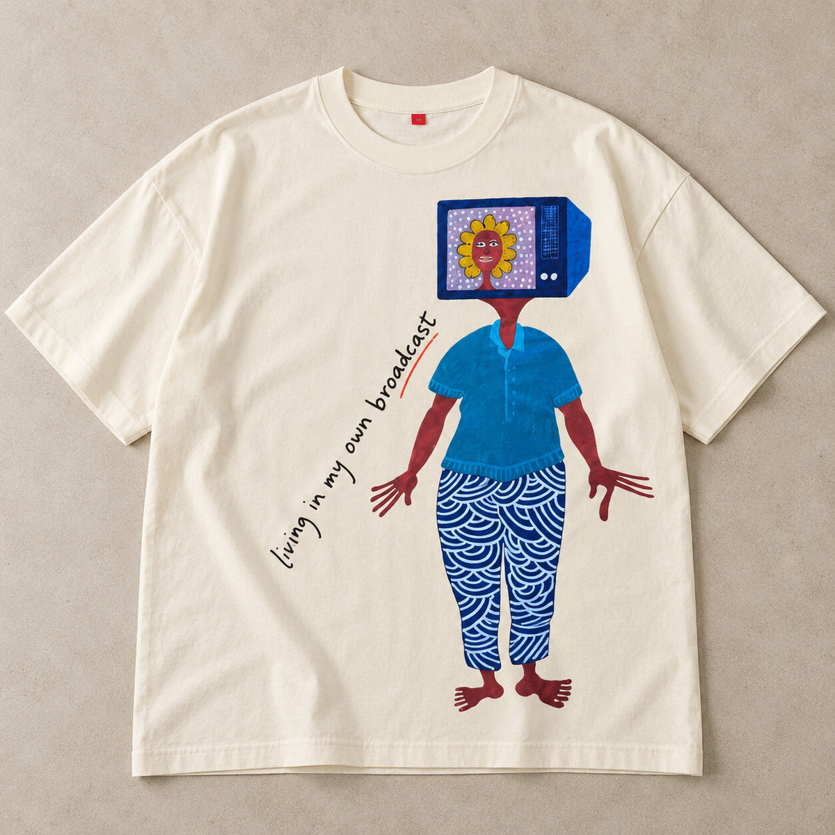 Flat-lay: oversized cream Broadcast printed T-shirt